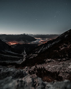 Scenic view of snowcapped mountains against sky at night