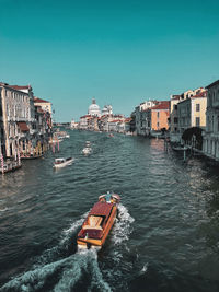 View of buildings by sea against clear sky