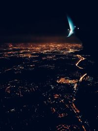 Aerial view of illuminated cityscape against sky at night