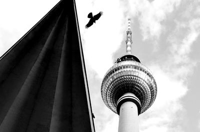 Low angle view of television tower against cloudy sky