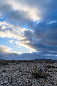 Scenic view of landscape against cloudy sky