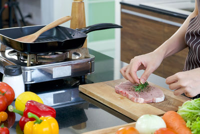Midsection of man preparing food in kitchen