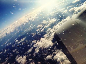 Aerial view of cloudscape over airplane wing