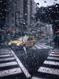 Road seen through wet car windshield