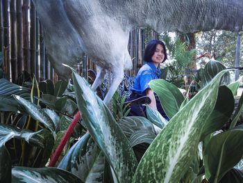 Woman sitting on leaves outdoors