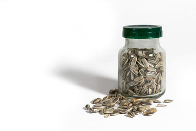 Close-up of coins on glass against white background