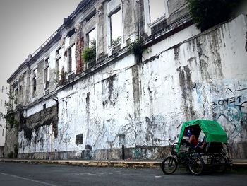 Rickshaw on street by building