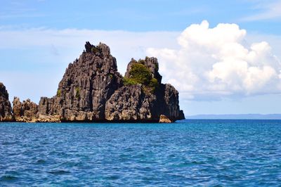 Scenic view of sea against cloudy sky