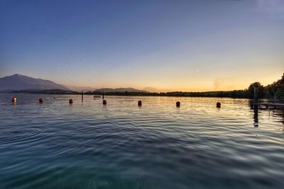 Scenic view of lake against sky during sunset