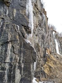 Low angle view of rock formation in water
