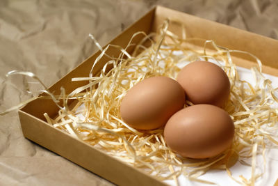 High angle view of eggs in basket on table