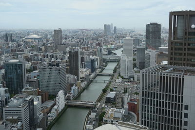 High angle view of buildings in city against sky