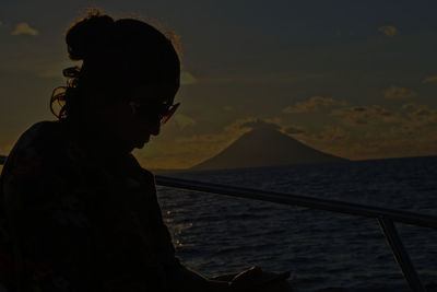 Portrait of silhouette man standing by sea against sky during sunset