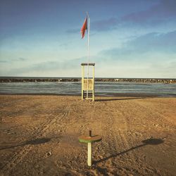 Lifeguard hut on beach against sky