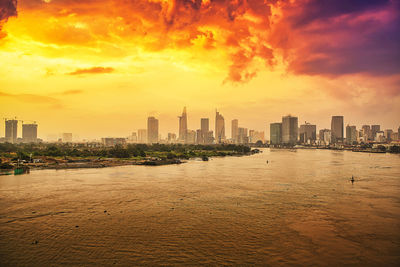 Scenic view of buildings against sky during sunset