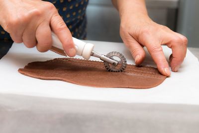 Close-up of person preparing food on table