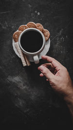 Man holding coffee cup on table