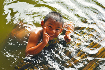 Portrait of boy swimming in water