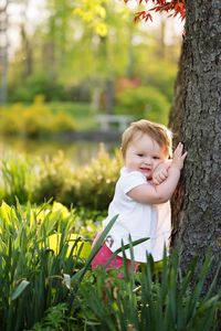 Portrait of baby girl by tree at park