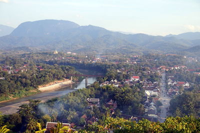 High angle view of river and mountains against sky