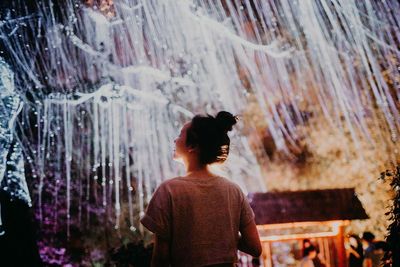 Rear view of woman standing outdoors