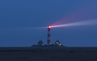 Lighthouse against clear sky at night