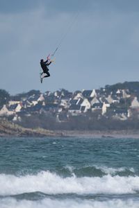 Kitesurfer during high jump above sea 