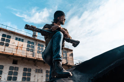 Low angle view of man against built structure