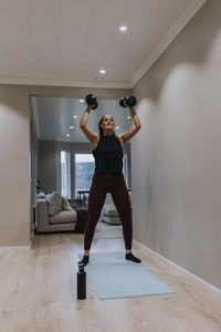 View of woman exercising at home