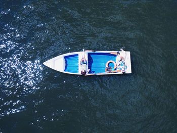 High angle view of people relaxing in boat on sea