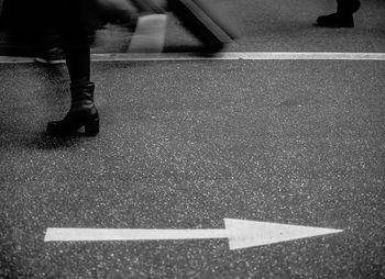 Low section of man standing on tiled floor