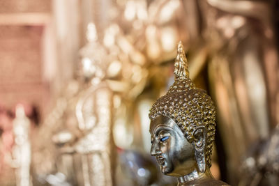 Close-up of statue against temple outside building