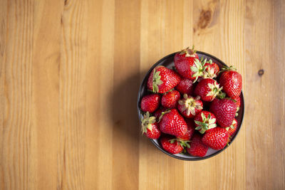 High angle view of strawberries in bowl on table