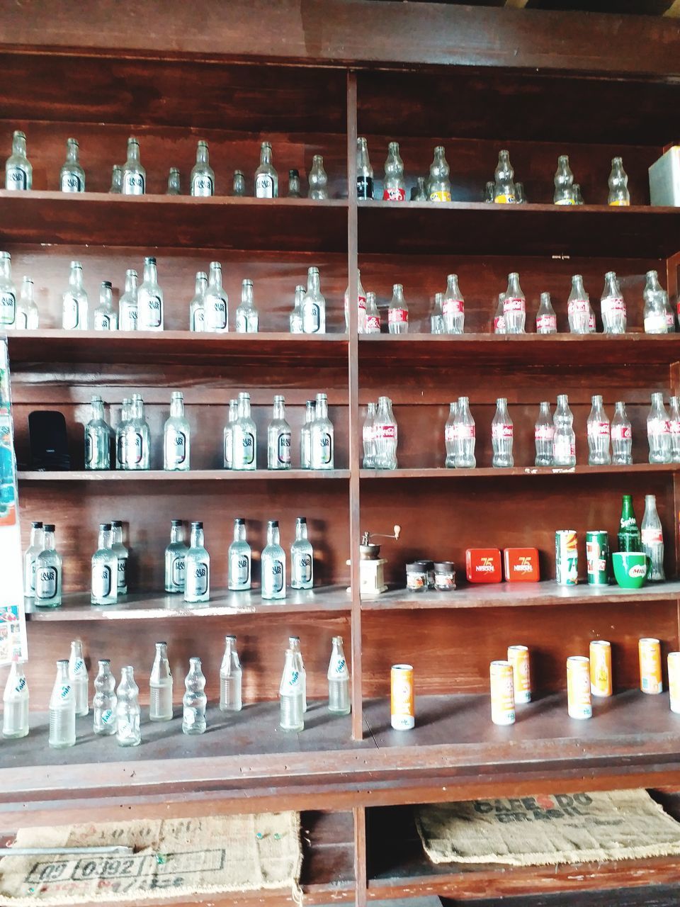 FULL FRAME SHOT OF BOTTLES IN ROW