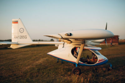 Airplane on airport runway against sky