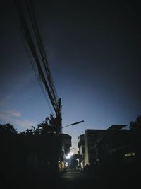 Low angle view of silhouette buildings against sky at night