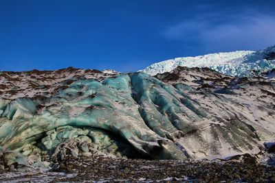 Scenic view of snowcapped mountain against blue sky