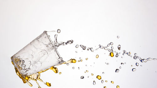 Close-up of water splashing against white background