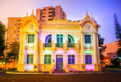 Low angle view of illuminated building against sky