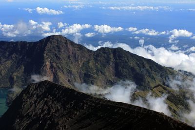 Scenic view of mountain range against cloudy sky