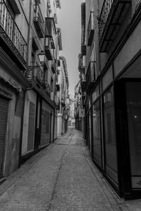 Empty alley amidst buildings in city