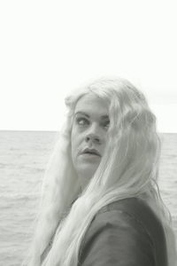 Portrait of woman against clear sky