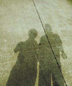 Shadow of people on road