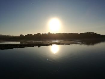 Scenic view of lake against sky during sunset