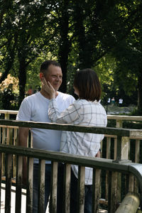 Portrait of a young couple on a bridge in the park.