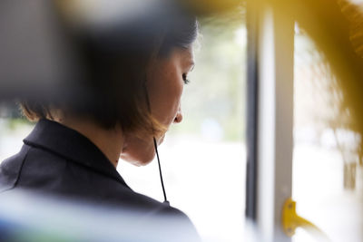 Rear view of businesswoman sitting in bus