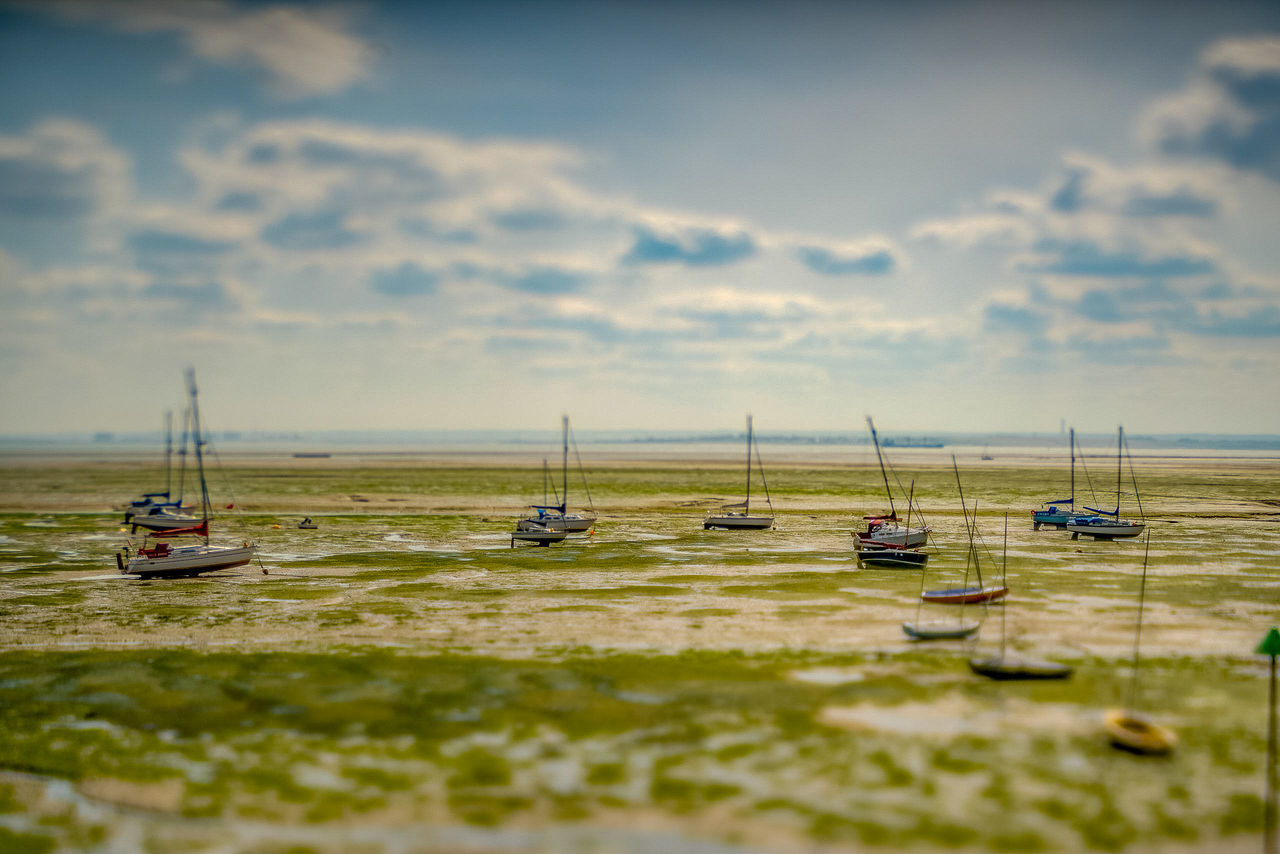 TILT-SHIFT IMAGE OF BOATS ON SHORE