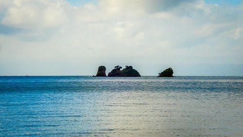 Scenic view of sea against cloudy sky