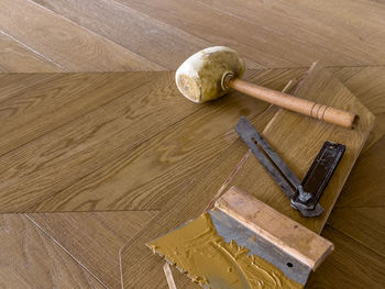 High angle view of hammer on wooden table