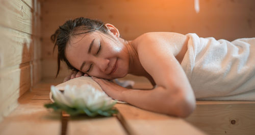 Young woman lying on bed in spa